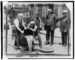 1921 police raid pours confiscated liquor into sewer during alcohol Prohibition